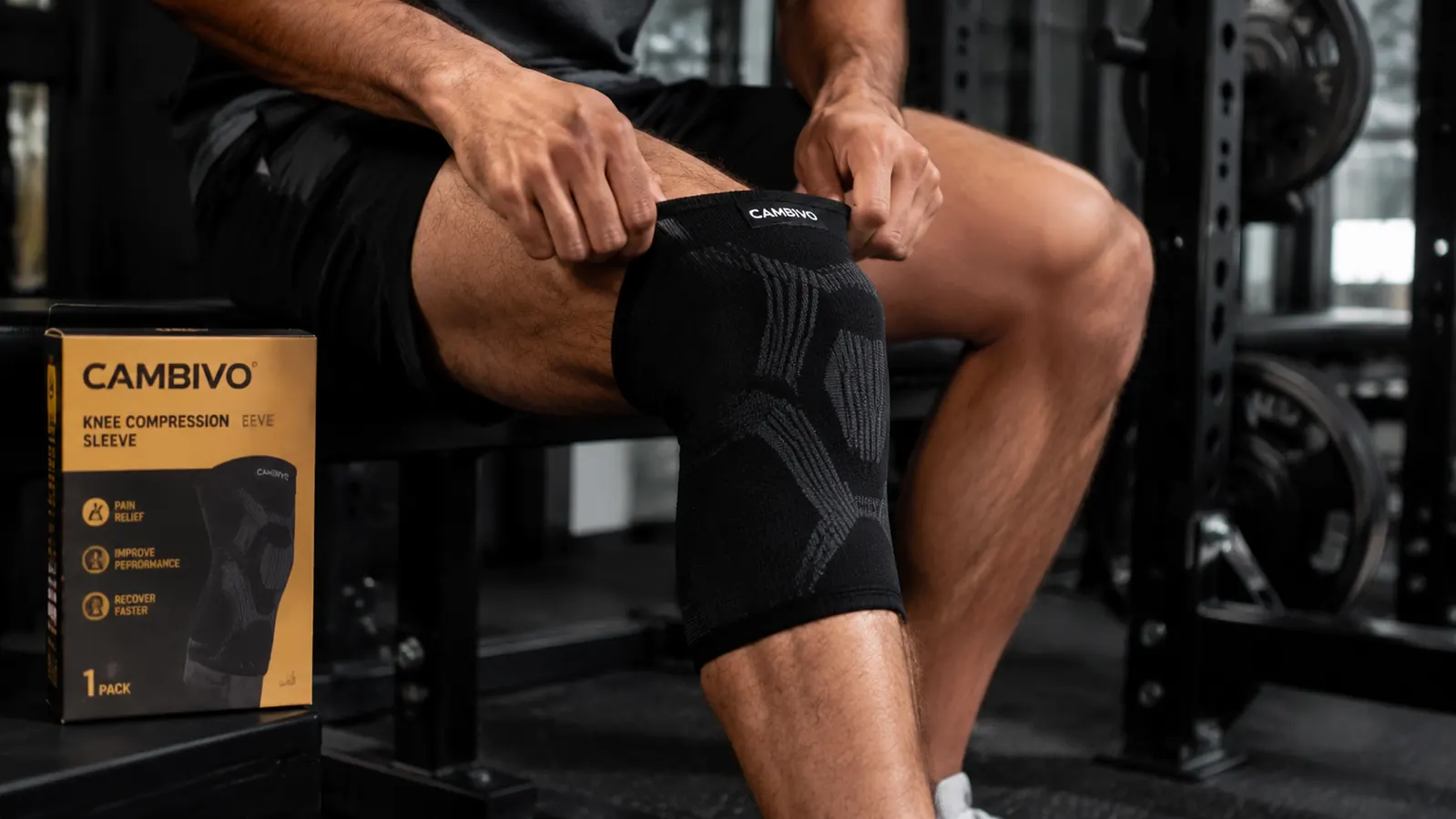 Person pulling on a CAMBIVO knee sleeve before a squat workout