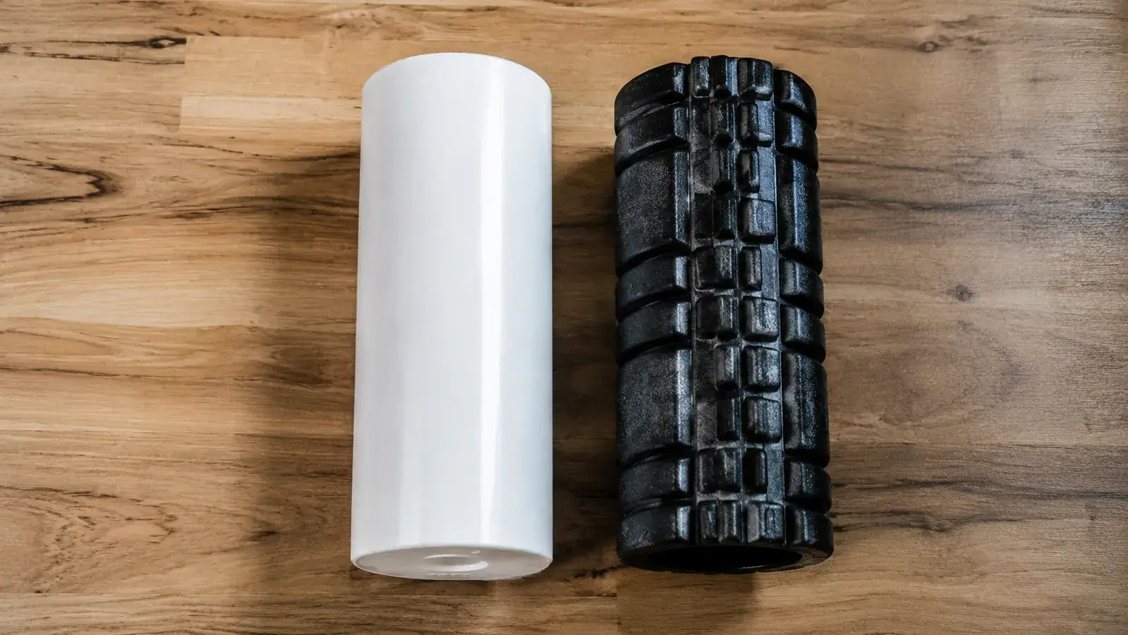 Close-up of the TriggerPoint CORE foam roller surface texture next to a hard PVC roller for comparison