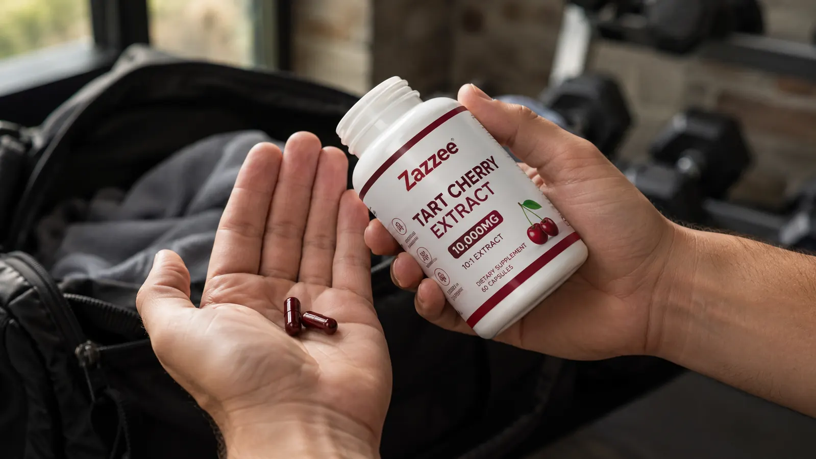 Zazzee tart cherry extract bottle standing upright on a nightstand next to a glass of water